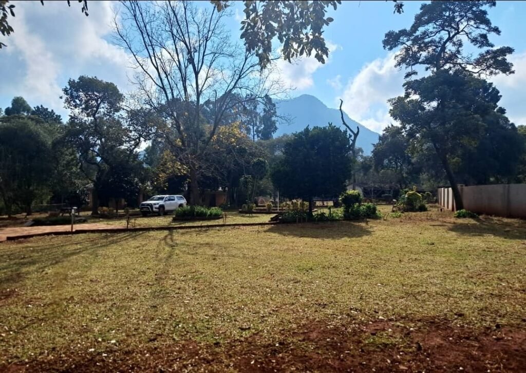 Outdoor view of the lodges and gardens at Kylelikwe Park guest house in Masvingo.